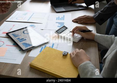 Group of business people analysis summary graph reports of business operating expenses and work data about the company's financial statements. Stock Photo