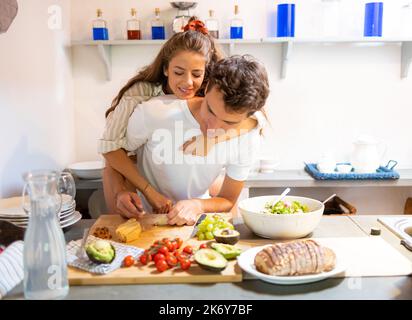 Young couple having fun in the kitchen in the morning, while preparing breakfast Stock Photo