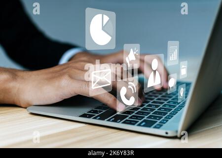 DMS. businessman using laptop computer with virtual graphic icon on desk at home, document management, digital marketing, data management system, busi Stock Photo