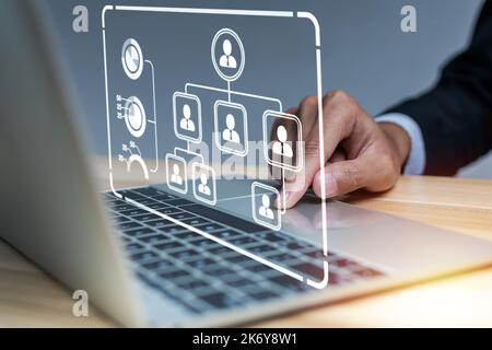 businessman hand touching on laptop computer with digital business organization chart icon diagram in meeting room office, human resource, job intervi Stock Photo