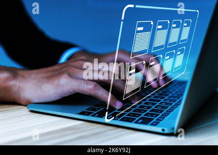Document Management System. businessman using laptop computer with virtual graphic icon on desk at home, document management, digital marketing, busin Stock Photo