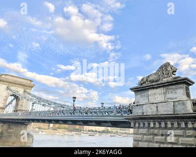 Lion sculpture on the Széchenyi Chain Bridge. A chain bridge that spans the Danube river between Buda and Pest. Stock Photo