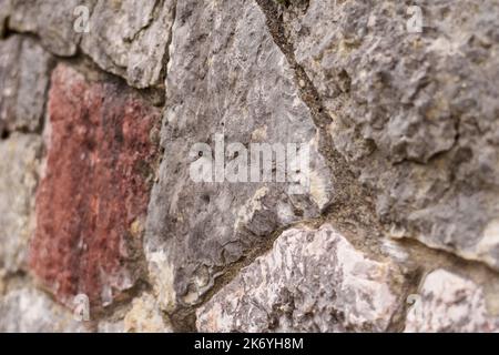 Stone wall. Uneven rough rock surface. Abstract background Stock Photo