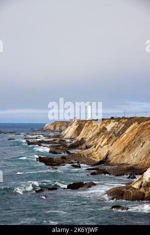 View of Point Arena Lighthouse on a rocky seashore in California by historic route 101 Stock Photo