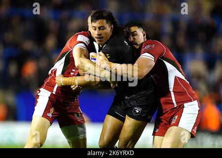 New Zealand's Joseph Tapine (centre) is tackled by Lebanon's Kayne Kalache and Khaled Rajab during the Rugby League World Cup group C match at the Halliwell Jones Stadium, Warrington. Picture date: Sunday October 16, 2022. Stock Photo