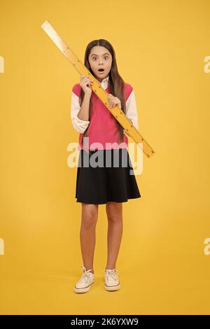 surprised teen girl study math with ruler measuring size, back to school Stock Photo