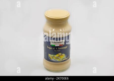 Kyiv, Ukraine - June 01, 2022: Studio shoot of Italiamo 4 Cheese Sauce bottle closeup on white. Creamy cheese sauce for pasta and salad in glass jar. Stock Photo