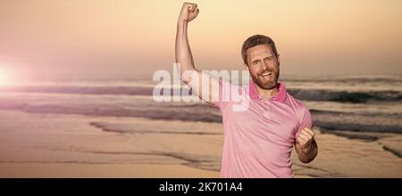 Man face portrait, banner with copy space. successful guy on sunrise beach. bearded man in shirt. celebrate success. summer vacation. Stock Photo