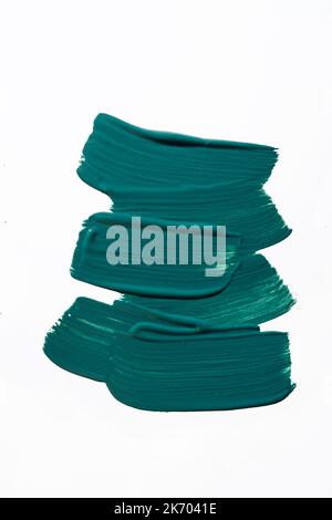 Dark teal paint smear on white background. Macro shot. Trendy color of 2023 and 2024 Stock Photo