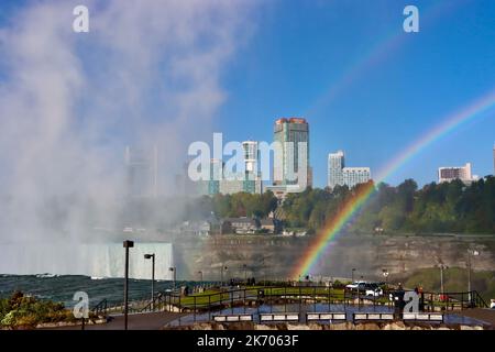 Rainbow over the falls seen from the American side of the falls Stock Photo