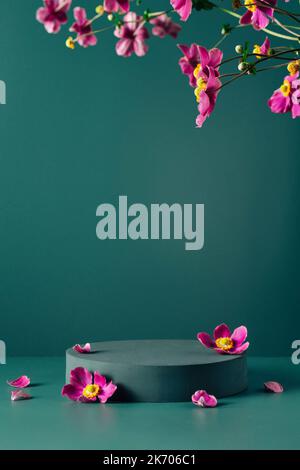 Podium, stand, showcase and brigth purple flowers on dark teal background. Mock up scene. Trendy color 2023 Stock Photo