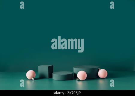 Abstract christmas composition template for exhibition beauty product on dark teal background. Geometric podiums and pink christmas balls on dark turquoise background. Winter sale. Trendy color 2023 Stock Photo