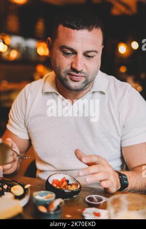 Middle aged man sitting in a bar having breakfast Stock Photo