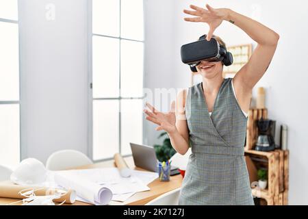 Young caucasian woman smiling confident using vr goggles working at architecture studio Stock Photo