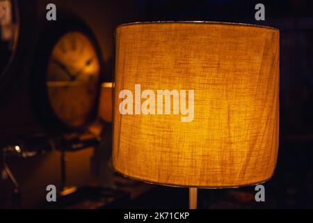 Cozy room interior with the lampshade . Bedroom in low light Stock Photo