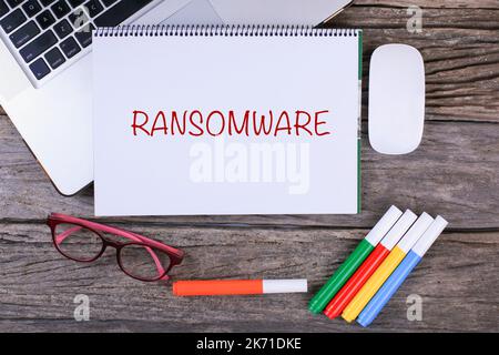 RANSOMWARE text on wooden desk with tablet pc and keyboard Stock Photo