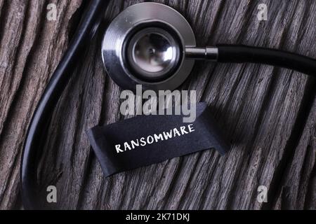Medical Concept- RANSOMWARE word written on label tag with Stethoscope on wood background Stock Photo