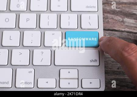 Close up of finger on keyboard button with RANSOMWARE  word Stock Photo