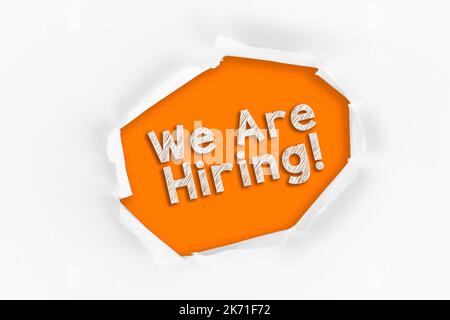 Torn paper with a We Are Hiring word on red background Stock Photo