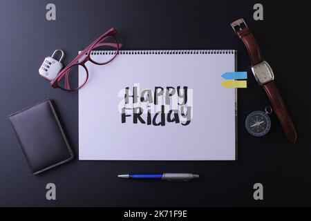 Travel concept with notebook written Happy Friday with passport, watch, ball pen and watch, copyspace area Stock Photo