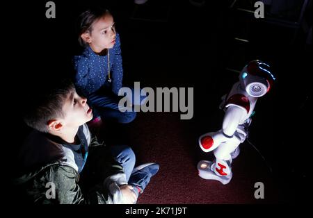 Bucharest, Romania. 16th Oct, 2022. Children interact with a small intelligent robot while visiting the 3rd edition of the new media art festival RADAR in Bucharest, capital of Romania, Oct. 16, 2022. Credit: Cristian Cristel/Xinhua/Alamy Live News Stock Photo