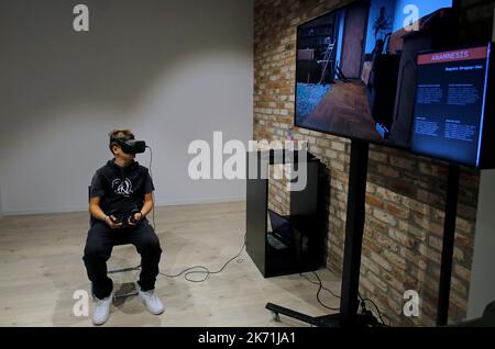 Bucharest, Romania. 16th Oct, 2022. A boy experiences virtual reality goggles while visiting the 3rd edition of the new media art festival RADAR in Bucharest, capital of Romania, Oct. 16, 2022. Credit: Cristian Cristel/Xinhua/Alamy Live News Stock Photo