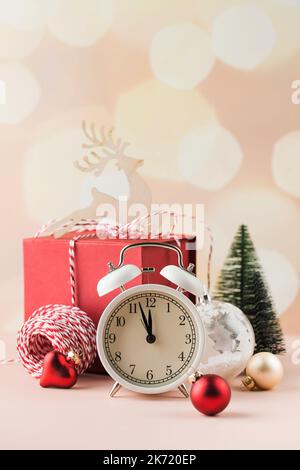 Christmas composition with holiday decorations, alarm clock and gift box.  Stock Photo
