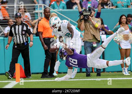 Sunday, October 16, 2022; Miami Gardens, FL USA;  Minnesota Vikings wide receiver Justin Jefferson (18) stretches trying to hit the pylon while tackle Stock Photo