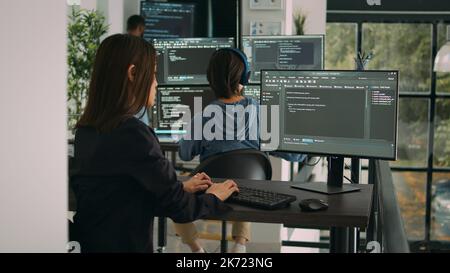 Database developer using computer to write code on terminal window, creating new web interface at desk. Coder working and parsing system algorithm in software agency office, it server. Stock Photo