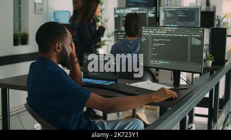 Software programer brainstorming ideas to write code and create security program, displaying artificial intelligence algorithm. Pensive app developer thinking about database cloud computing. Stock Photo