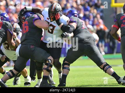 Fort Worth, Texas, USA. 15th Oct, 2022. TCU Horned Frogs offensive lineman Alan Ali (56) and TCU Horned Frogs guard Wes Harris (78) double team Oklahoma State Cowboys defensive tackle Collin Clay (93) during the 1st half of the NCAA Football game between the Oklahoma State Cowboys and TCU Horned Frogs at Amon G. Carter Stadium in Fort Worth, Texas. Matthew Lynch/CSM/Alamy Live News Stock Photo