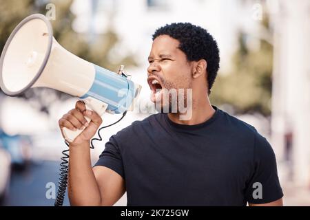 Megaphone, protest and angry black man talking at riot in Nigeria. Announcement, loudspeaker and shouting or screaming male on bullhorn protesting for Stock Photo