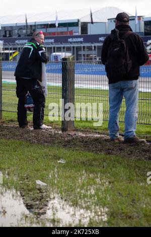 Phillip Island, Australia, 16 October, 2022. Fans stand deep in mud during The 2022 Australian MotoGP at The Phillip Island Circuit on October 16, 2022 in Phillip Island, Australia. Credit: Dave Hewison/Speed Media/Alamy Live News Stock Photo