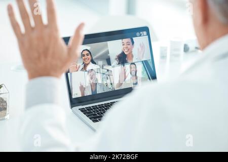 That was a great conference, thanks. an unrecognisable doctor sitting in his clinic and using his laptop for a conference call. Stock Photo