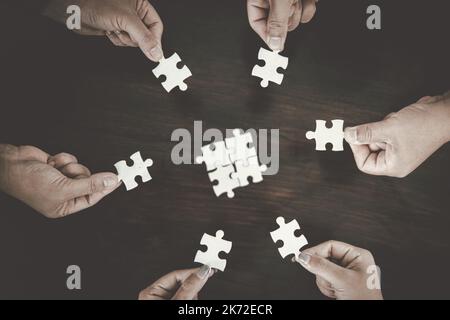 Business group connect pieces of puzzle think of problem solving. Brainstorm, decision concept. Stock Photo