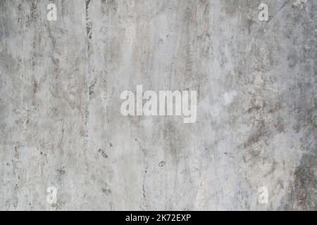 Gray concrete wall with dirty marks and cracks Stock Photo