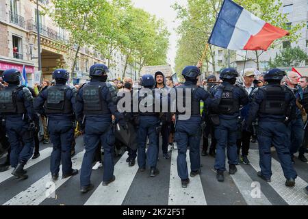 Paris, Ile de France, FRANCE. 16th Oct, 2022. French riot police tries to hold back protesters during a march in the center of Paris against increasingly expensive daily life and climate change. The march was organised by the hard left wing la France insoumise, or France unbowed and French ecologists known together as NUPES. The Police say 30.000 people participated while the organisers claim that 140.000 protesters took part in the march. (Credit Image: © Remon Haazen/ZUMA Press Wire) Stock Photo