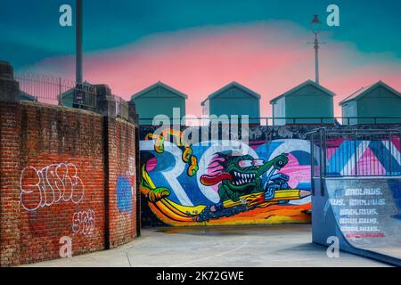 The skate park at The Big Beach Cafe owned by Fat Boy Slim (Norman Cook) on Hove seafront with the beach huts and colourful street art against a sunse Stock Photo