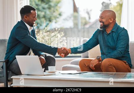 Well make magic together. two businessmen shaking hands in agreement. Stock Photo