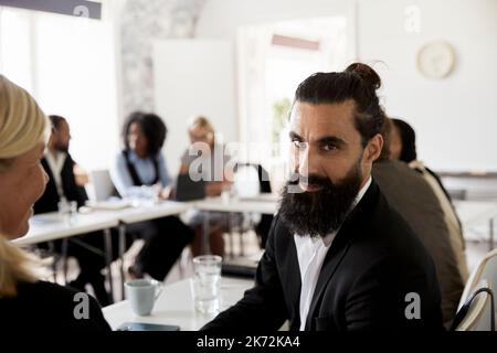 Businessman looking at camera during business meeting Stock Photo