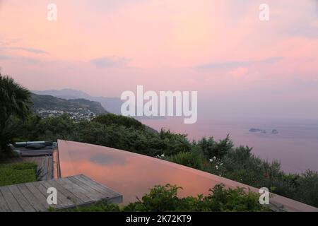 Evening sky reflecting in infinity pool Stock Photo