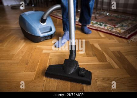 Woman vacuuming living room Stock Photo