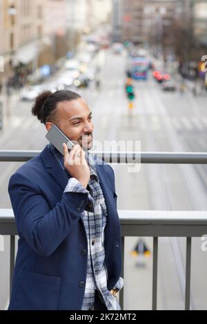 Smiling man talking via cell phone Stock Photo