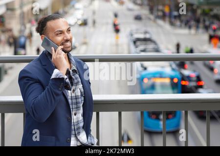 Smiling man talking via cell phone Stock Photo