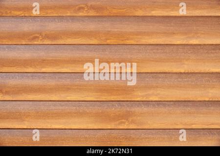 Facade cladding from solid wood handmade boards in brown color Stock Photo