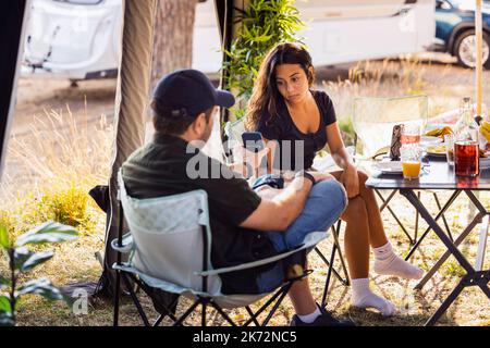 Father with teenage daughter at camping Stock Photo