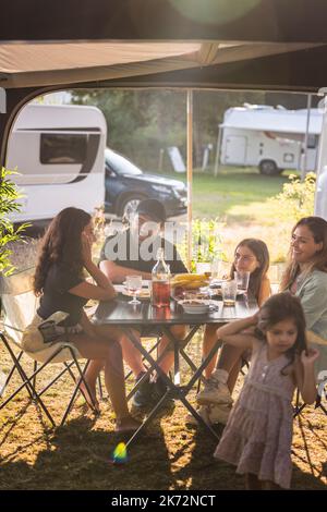 Family having meal at camping Stock Photo