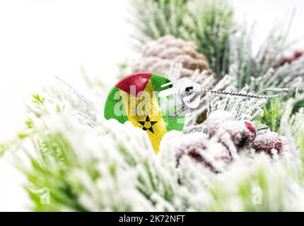 New Year's colorful background with a ball on which the flag of Sao Tome and Principe is depicted. The concept of the New Year holiday and Christmas. Stock Photo