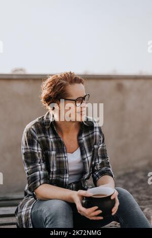 Smiling woman having coffee Stock Photo