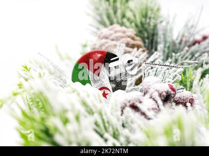 New Year's colorful background with a ball on which the flag of Western Sahara is depicted. The concept of the New Year holiday and Christmas. Stock Photo